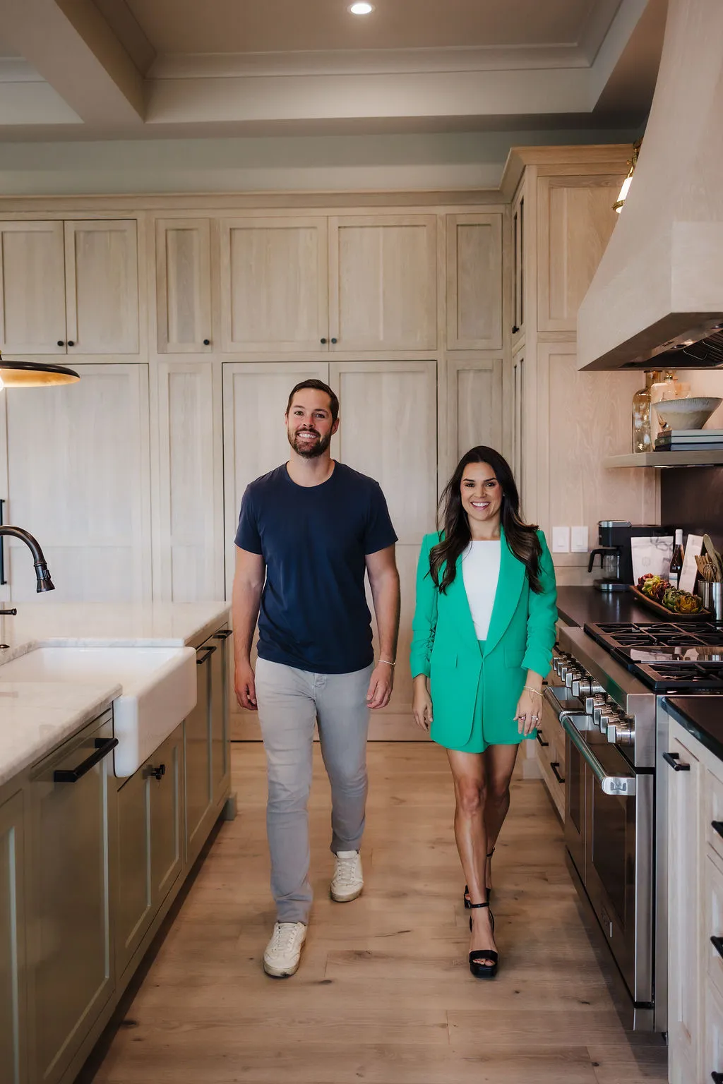 MyOps founders Jonathan Spears and Maria Coukoulis walking side by side through a bright kitchen